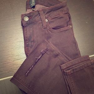 Wine Colored skinny jeans with a slit in the knee